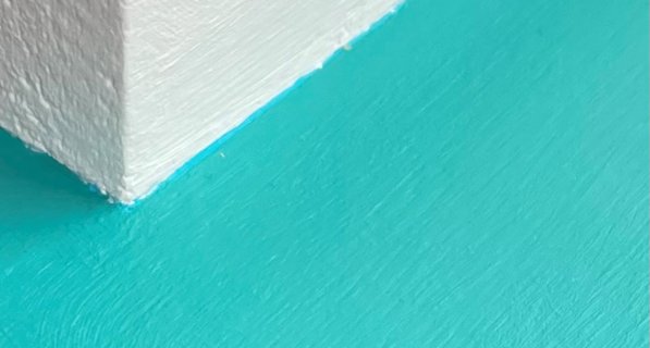 White wall with a light blue ledge attached to it
