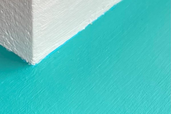 White wall with a light blue ledge attached to it