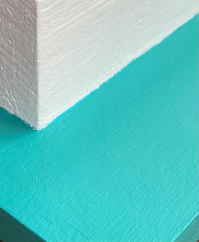 Corner of a wall with a light blue ledge going around it