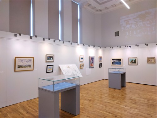 inside exhibition space with pictures on walls